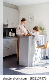 Happy Siblings Slicing And Peeling Aplle Using Apple Peeler Corer Slicer Machine. Children Cooking Charlotte Or Apple Pie At Modern Kitchen At Home Together. 