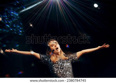
Happy Singer Performing on a Stage at her Own Show. Portrait of a musical artist singing in a concert event
