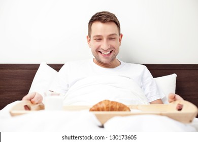 Happy Single Man Eating Breakfast In Bed