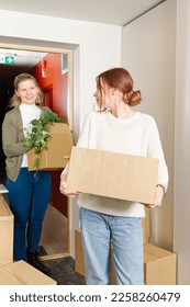 happy single mother with childrens moves to a new house. Moving day concept. children carry cardboard boxes when moving. - Shutterstock ID 2258260479