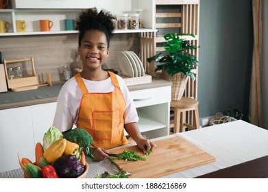 Happy sister black skin with salad on plate in kitchen  - Shutterstock ID 1886216869