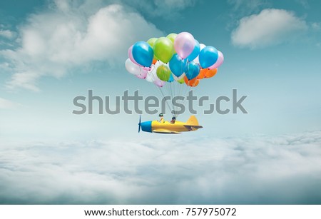 Happy sister enjoy with fantasy plane fly  and floating in sky with bunch of colorful balloons .