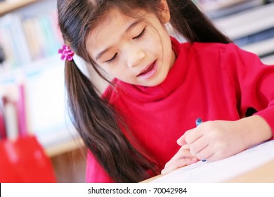 Happy Six Year Old Girl Drawing With Crayon