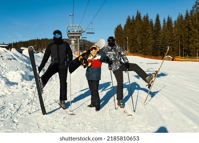 Happy Skiers In Mountain Resort In Sunny Day