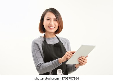 Happy Small Business Owner In Apron Holding Tablet Standing Against White Background