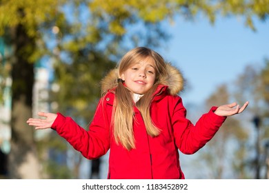 Happy Small Girl In Autumn Park. Small Girl Did It In Mistake. Oops. Even The Wisest Of Us Can Make A Mistake. The First Touches Of Autumn. Enjoy Happy Childhood.