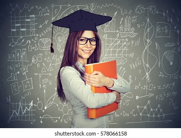 Happy Smart Girl Student With Graduation Cap And Folder Over High School Math And Science Formulas On Blackboard  