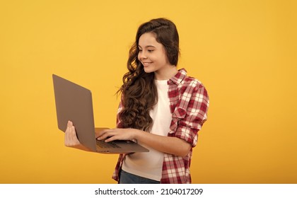 happy smart kid typing on laptop during school online lesson, modern education - Shutterstock ID 2104017209