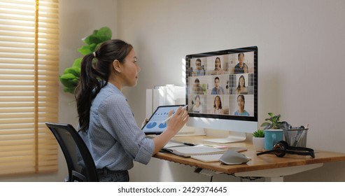 Happy smile asia young talent woman learn mba college class on webcam video call in desktop screen with cowork friend workforce group talk in sale report. Smart job work at home for staff workspace. - Powered by Shutterstock