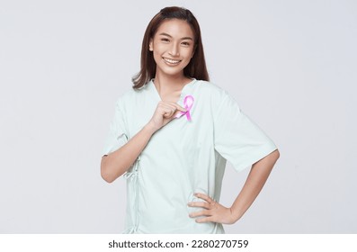 Happy smile asian woman patient showing pink badge ribbon chest to support breast cancer cause campaign. breast cancer awareness concept. - Powered by Shutterstock