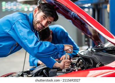 Happy smile Caucasian automobile mechanic man checking car damage broken part  condition, diagnostic and repairing vehicle at garage automotive, motor technician maintenance after service concept