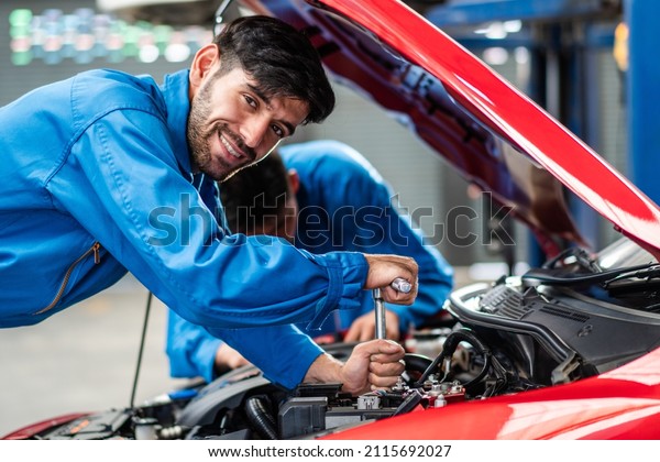 Happy smile Caucasian automobile mechanic man\
checking car damage broken part  condition, diagnostic and\
repairing vehicle at garage automotive, motor technician\
maintenance after service\
concept