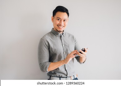 Happy Smile Face Of Handsome Asian Man Use Smartphone.