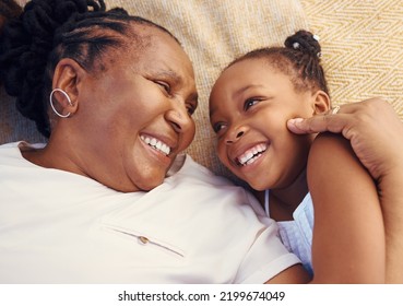 Happy, Smile And Family Of A Black Grandma And Child In Happiness Relaxing And Lying On A Bed At Home. Senior African Grandmother And Little Girl In Joyful, Love And Smiling Together In The Bedroom