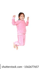 Happy And Smile Little Asian Child Girl In Pink Tracksuit Or Sport Cloth Jumping On Air Isolated Over White Background. Freedom Kid Movement Concept.