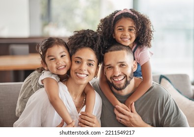 Happy, smile and portrait of an interracial family sitting on a sofa in the living room at home. Happiness, love and adoptive parents bonding, embracing and relaxing with their children in the lounge - Shutterstock ID 2211549217