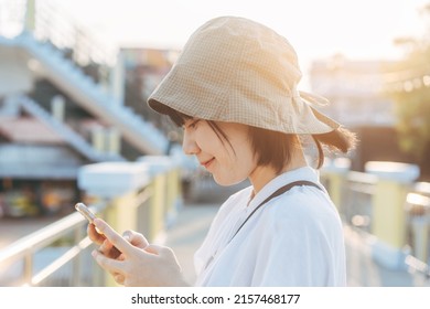 Happy Smile Young Adult Asian Woman Using Mobile Phone For Dating App Lifestyles At Out Door On Day.