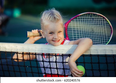 happy smiley cute little girl at the tennis competition