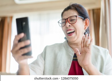 Happy Smiley Face Senior Woman Using Smartphone Video Call Camera With Facetime App And Talking With Her Family.Social Distancing.Stay Home.Covid-19 Coronavirus.Video Call Chat And Technology Concept.