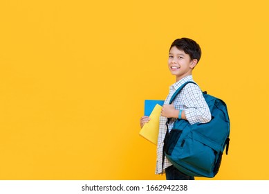 Happy Smiling 10 Year-old Mixed Race Boy With Backpack And Books Ready To Go To School