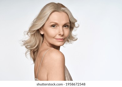 Happy smiling adult 50s aged woman looking at camera portrait isolated on white background. Hair and skin beauty care products advertising concept.