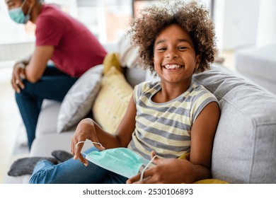 Happy smiling african american girl removes her annoying protective sterile medical mask - Powered by Shutterstock