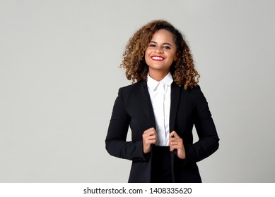 Happy smiling African American woman in formal business attire isolated on gray background