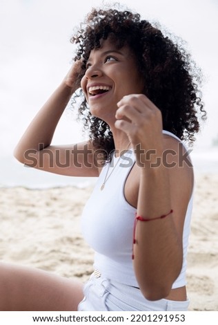 Happy smiling african american woman in the beach