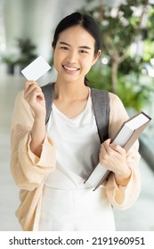 Happy Smiling Asian Female Student Holding Blank Credit Card, Concept Of Student Card, Student Loan, Scholarship Money, Educational Financial Credit