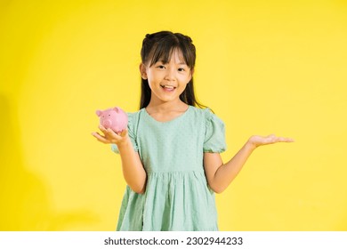 happy smiling asian girl on yellow background - Shutterstock ID 2302944233