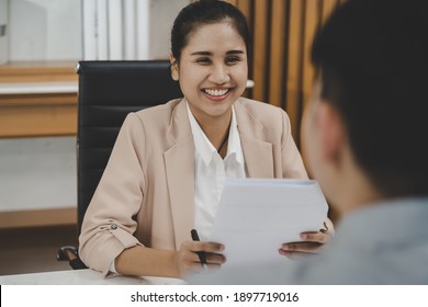 Happy, Smiling asian manager, employer woman interview with young man, have question about resume and listen to candidate answers, conversation together at office. Recruitment employee job concept. - Shutterstock ID 1897719016