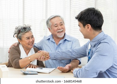 Happy Smiling Asian Old Couple Making Purchase And Mature Woman Handshake With Real Estate Agent, Sales Man Closing Deal From Business Agreement Contract, Concept For Retirement Or Lifestyle Insurance