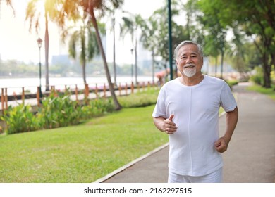 Happy and smiling asian senior man doing exercise and jogging or walking with relaxation for healthy in park outdoor after retirement during summer time. Health care elderly outdoor lifestyle concept. - Shutterstock ID 2162297515