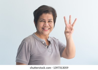 Happy Smiling Asian Senior Woman Pointing Up 3 Fingers