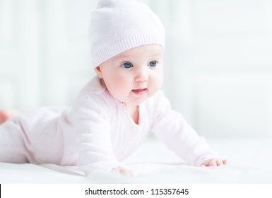 Happy Smiling Baby Girl In A Pink Knitted Hat