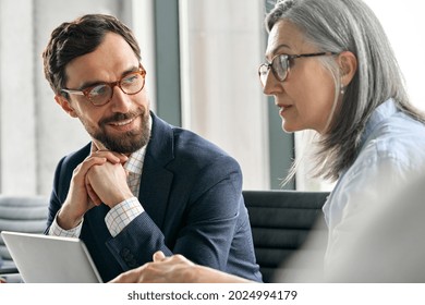 Happy Smiling Bearded Businessman In Eyewear With Clasped Hands Listening To Female Executive Manager Ceo Mentor In Glasses. Professional Business People Discuss Business Plan At Board Room Meeting.