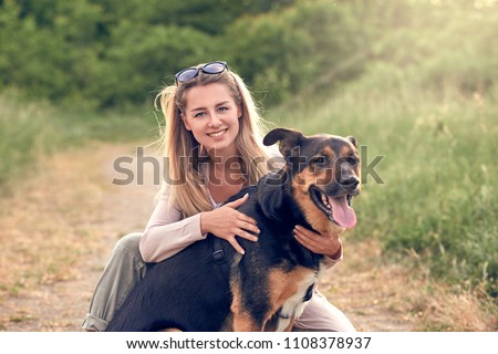 Similar – Pretty blond woman with her two dogs