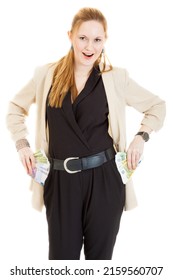 happy smiling blond long-haired young businesslady wearing black one-piecer and jacket gets out sheaf of bills (200 and 500 euros) from her pockets, isolated on white background