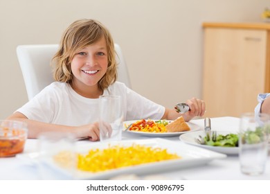 Happy smiling boy at the dinner table