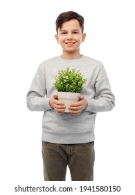 Happy Smiling Boy Holding Flower In Pot