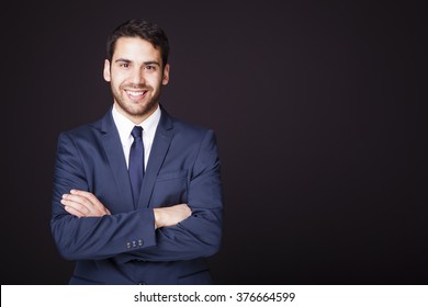 Happy Smiling Business Man With Crossed Arms On Black Background