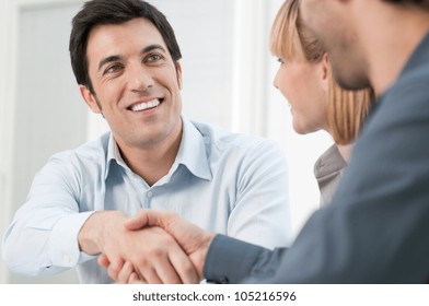 Happy Smiling Business Man Shaking Hands After A Deal In Office