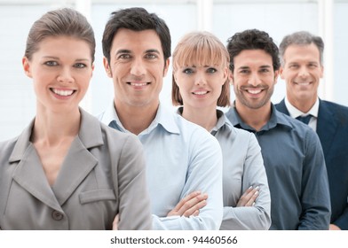 Happy Smiling Business Team Standing In A Row At Office