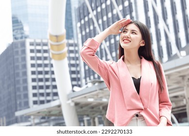 Happy smiling business woman standing outdoor looking high not fear hot UV sunlight from high protection sunscreen skin care - Powered by Shutterstock