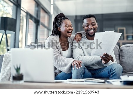 Happy, smiling and carefree black couple checking their finances on a laptop at home. Cheerful husband and wife excited about their financial freedom, savings, investment and future planning