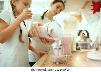 The happy smiling caucasian family in the kitchen preparing breakfast at home. Lifestyle, hapiness, family concept. - Powered by Shutterstock