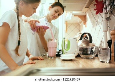 The happy smiling caucasian family in the kitchen preparing breakfast at home. Lifestyle, hapiness, family concept. - Powered by Shutterstock