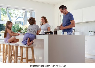 happy smiling caucasian family in the kitchen preparing breakfast