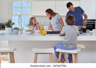 happy smiling caucasian family in the kitchen preparing breakfast - Powered by Shutterstock