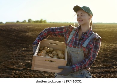 Happy smiling caucasian female potato farmer or gardener. Agriculture - food production, harvest concept - Powered by Shutterstock